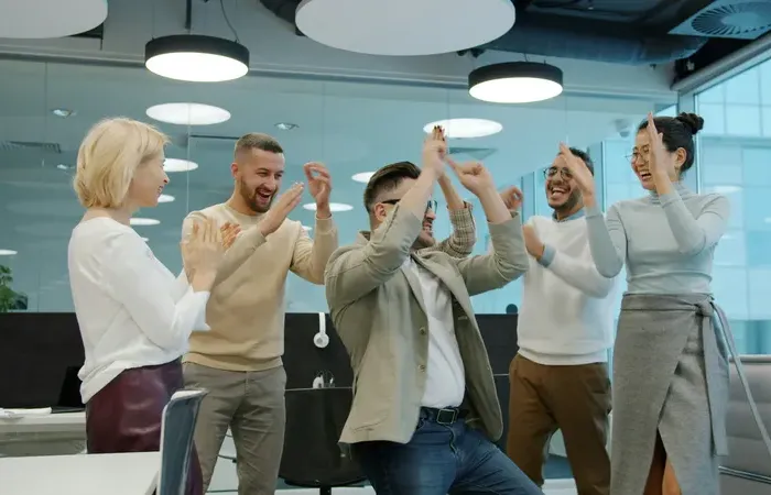 Office coworkers celebrating success together in a modern workspace promoted on towndirectoryplus.com